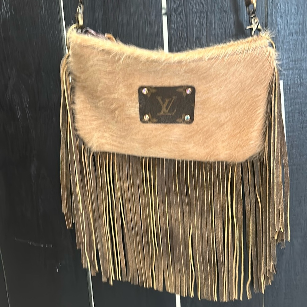 Leather fringe purse or use as a clutch with removable straps.